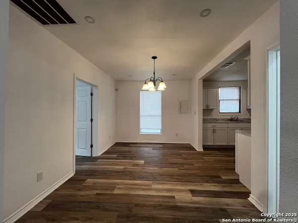 a view of a livingroom with wooden floor and a window