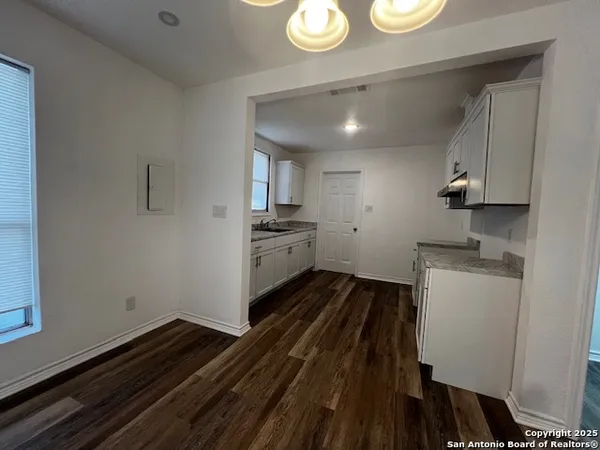 a kitchen with wooden cabinets and stove