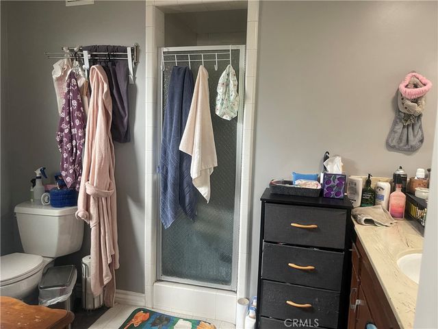 a bathroom with a sink mirror vanity and toilet