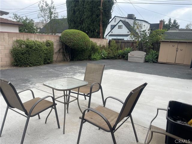 a view of a chairs and table in backyard