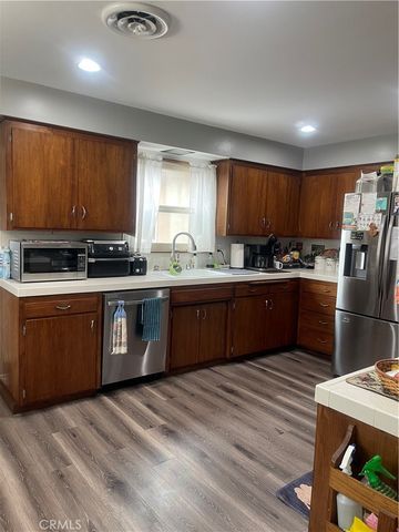 a kitchen with stainless steel appliances granite countertop a sink counter space cabinets and a window