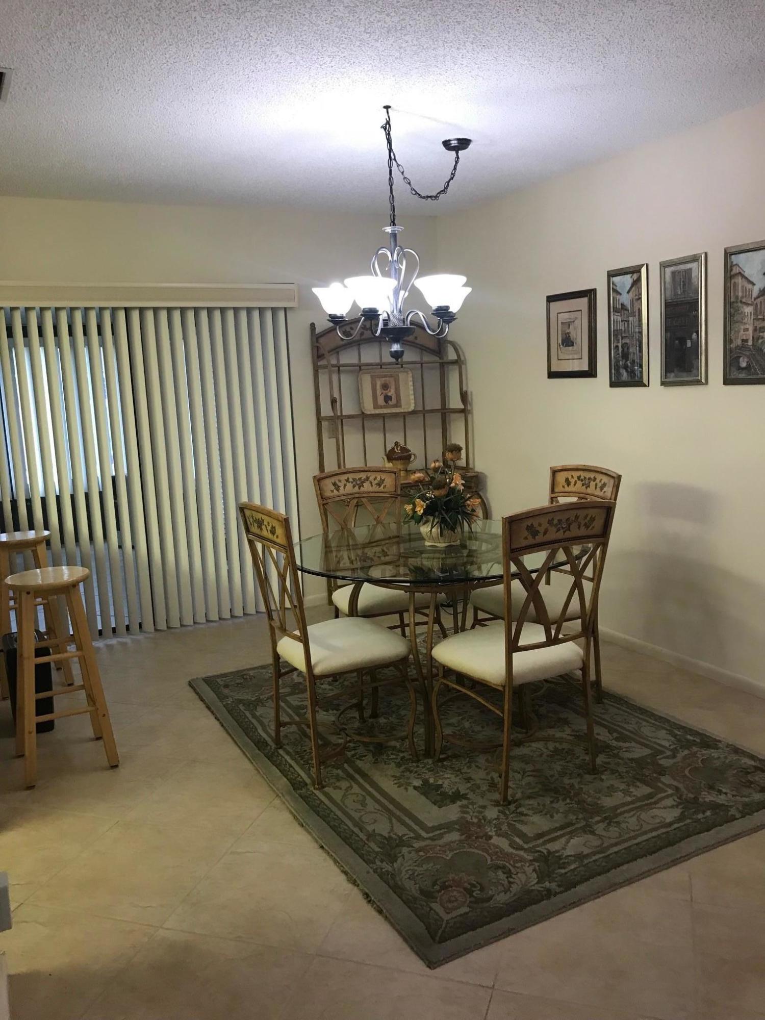 5173 Minto Road Boynton Beach, FL 33472 - Photo 5 of 19 a dining room with furniture and chandelier