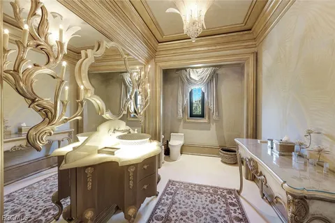 a bathroom with a granite countertop sink a mirror and a shower