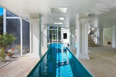 a view of a house with swimming pool and sitting area