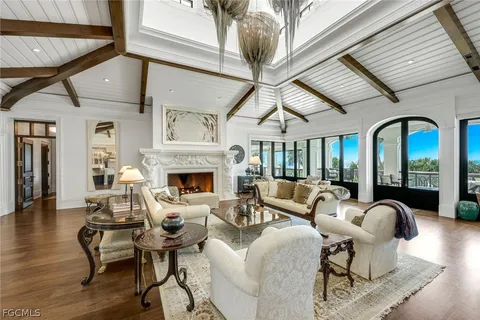 a living room with furniture a fireplace and wooden floor
