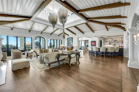 a living room with lots of furniture and a chandelier