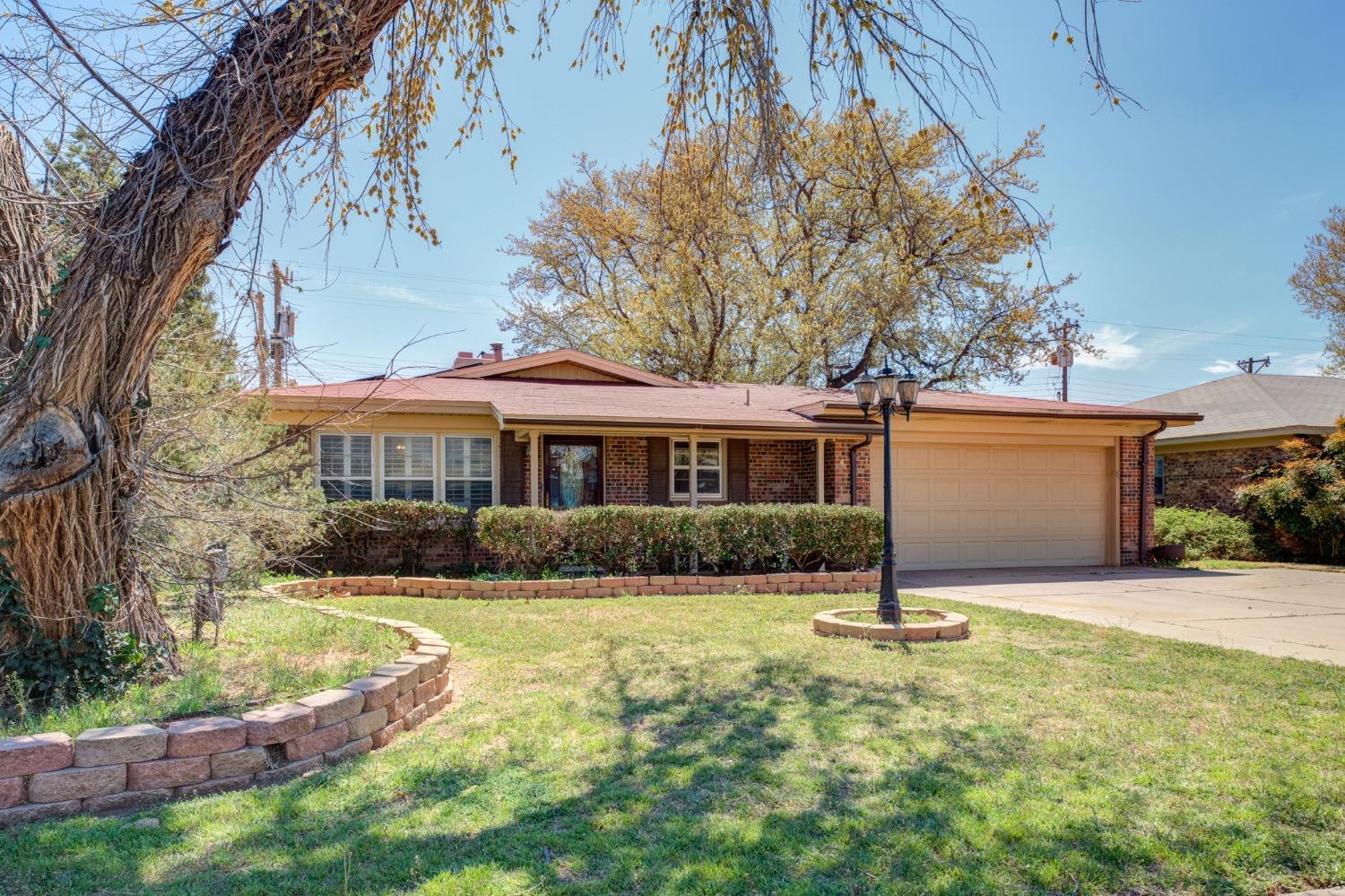 a front view of a house with yard and garage