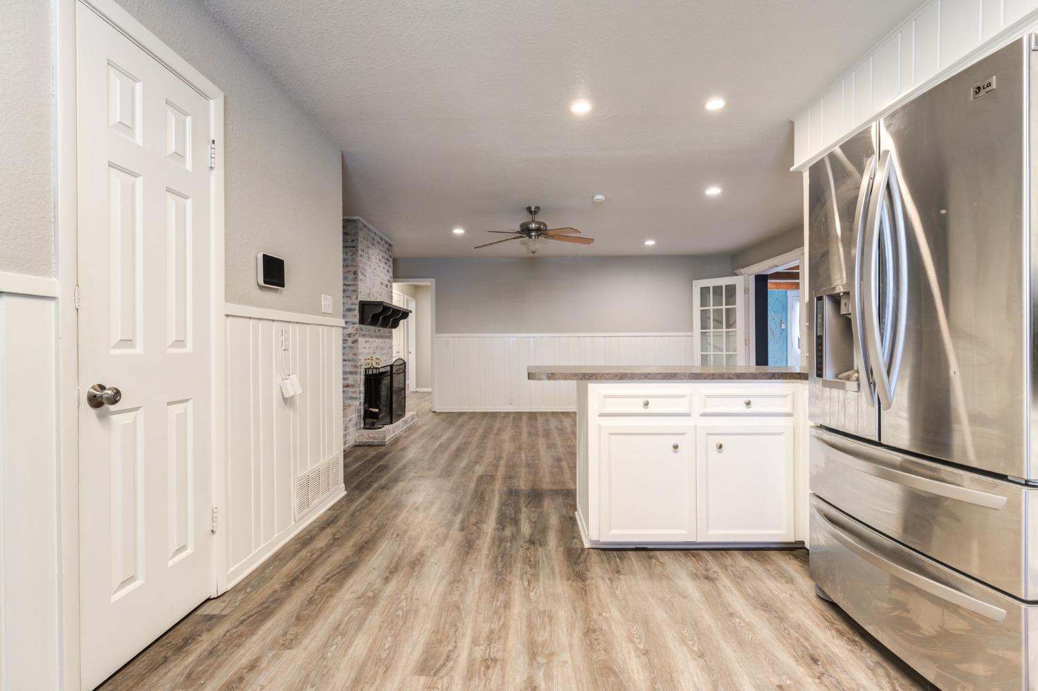 4409 49th Street Lubbock, TX 79414 - Photo 12 of 49 a kitchen with white cabinets and stainless steel appliances
