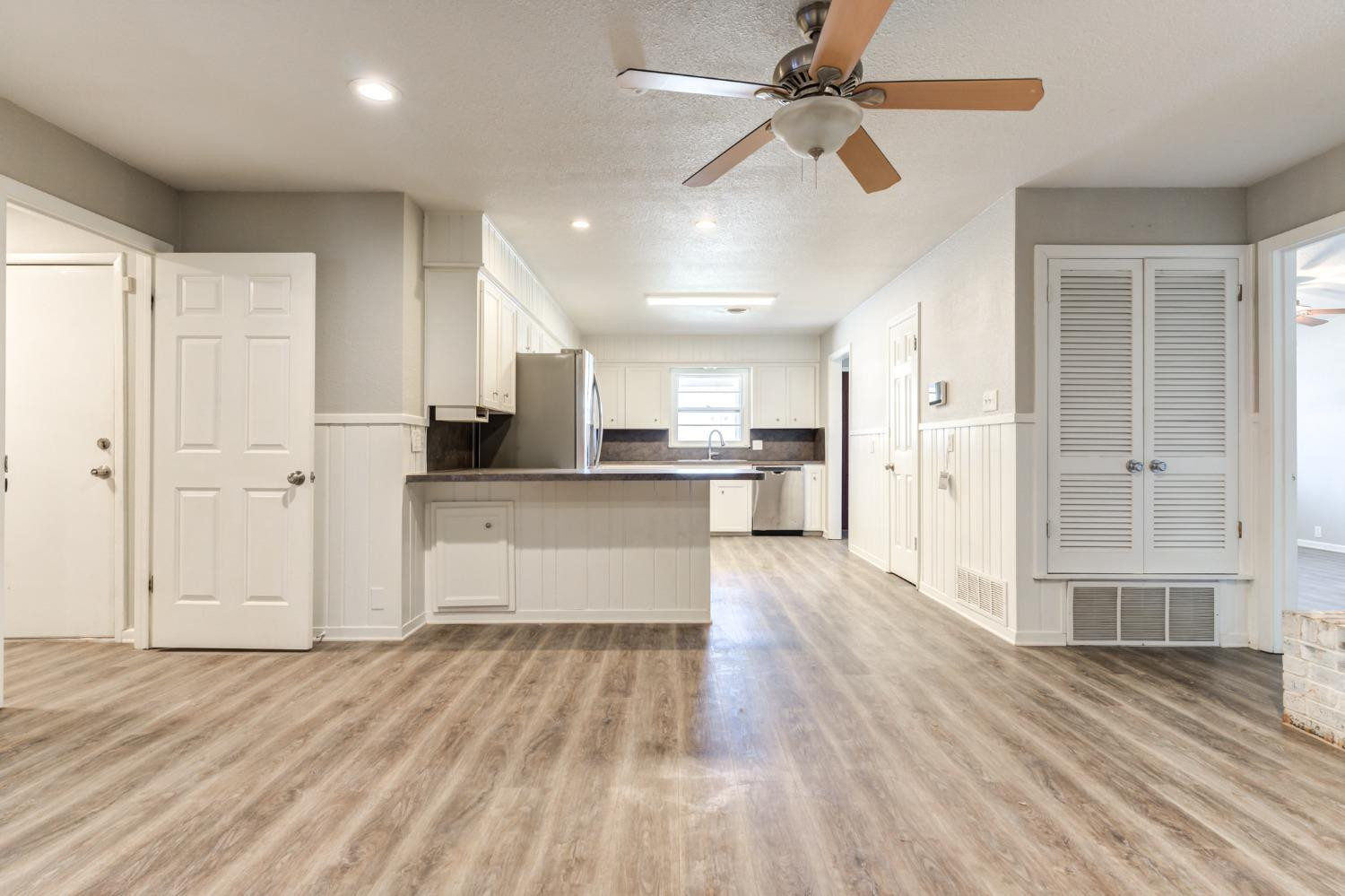 4409 49th Street Lubbock, TX 79414 - Photo 18 of 49 a view of kitchen with wooden floor and window