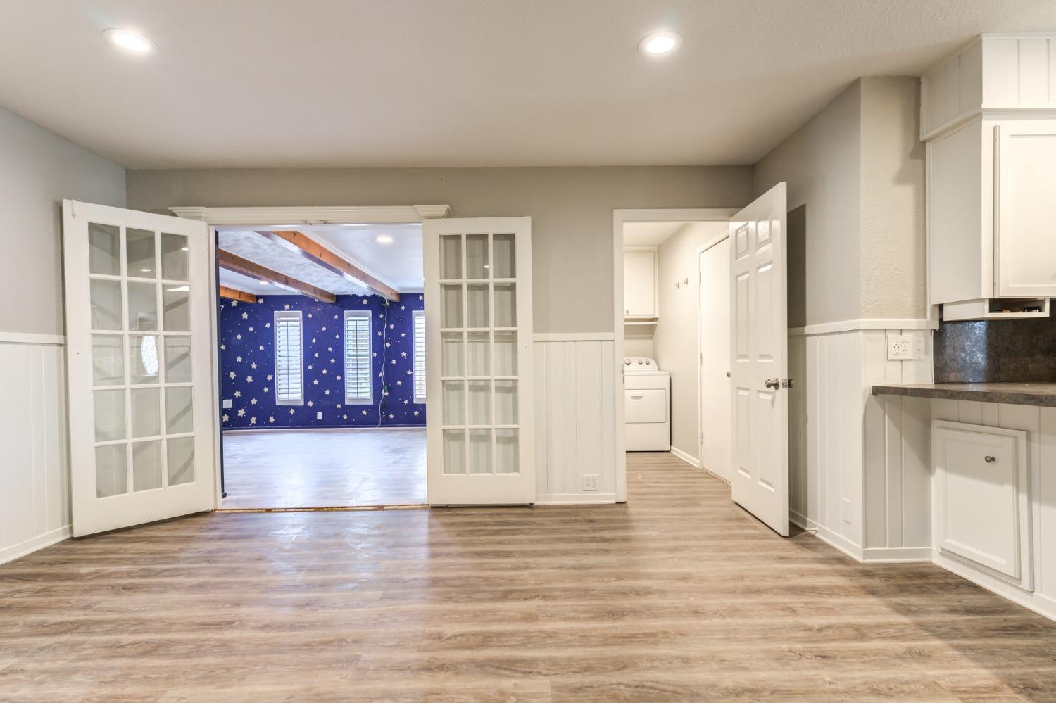 4409 49th Street Lubbock, TX 79414 - Photo 22 of 49 an empty room with wooden floor and windows