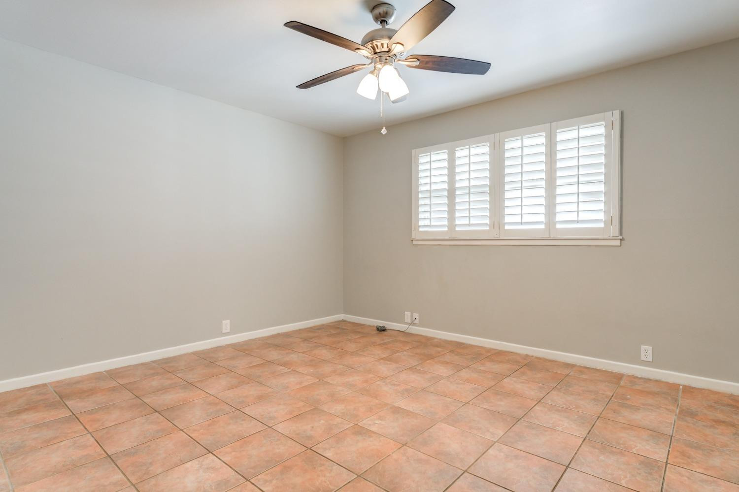 4409 49th Street Lubbock, TX 79414 - Photo 24 of 49 a view of a big room with windows and chandelier fan