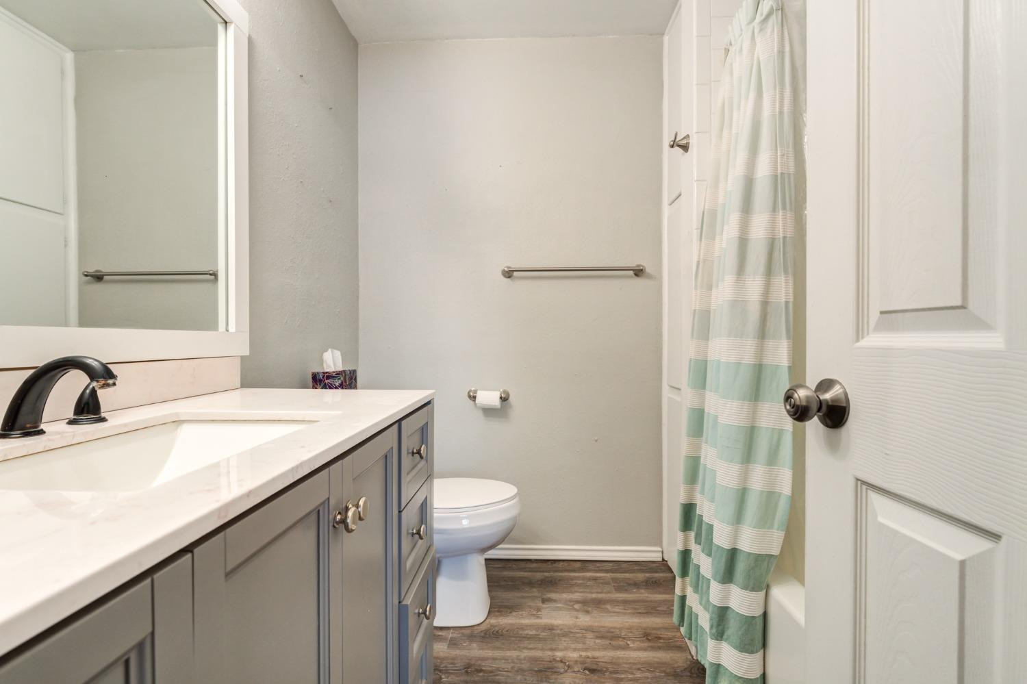 4409 49th Street Lubbock, TX 79414 - Photo 27 of 49 a bathroom with a sink toilet and shower