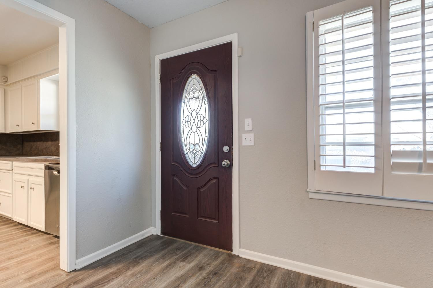 4409 49th Street Lubbock, TX 79414 - Photo 3 of 49 a view of a room with wooden floor closet and windows