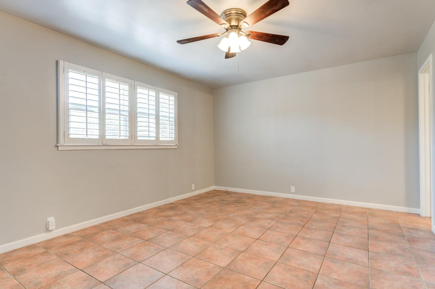 4409 49th Street Lubbock, TX 79414 - Photo 31 of 49 a view of an empty room with chandelier fan and a window