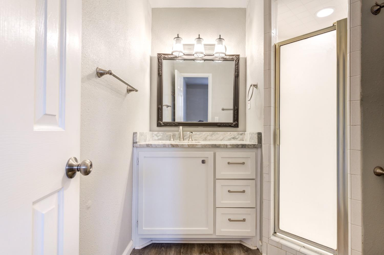 4409 49th Street Lubbock, TX 79414 - Photo 34 of 49 a bathroom with a sink and a mirror