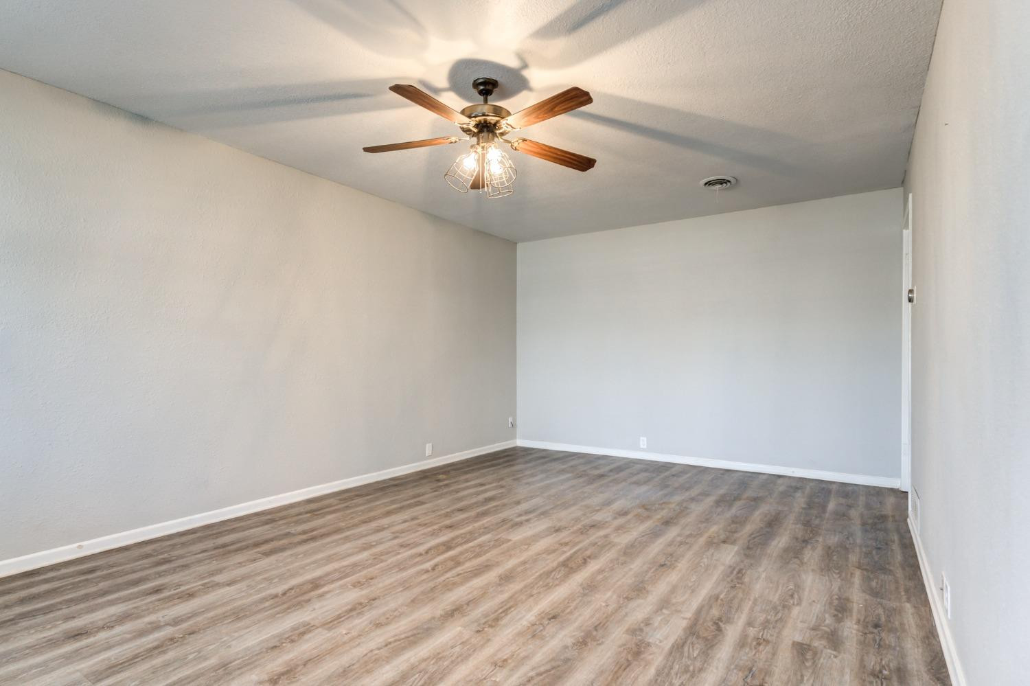 4409 49th Street Lubbock, TX 79414 - Photo 4 of 49 a view of an empty room with wooden floor