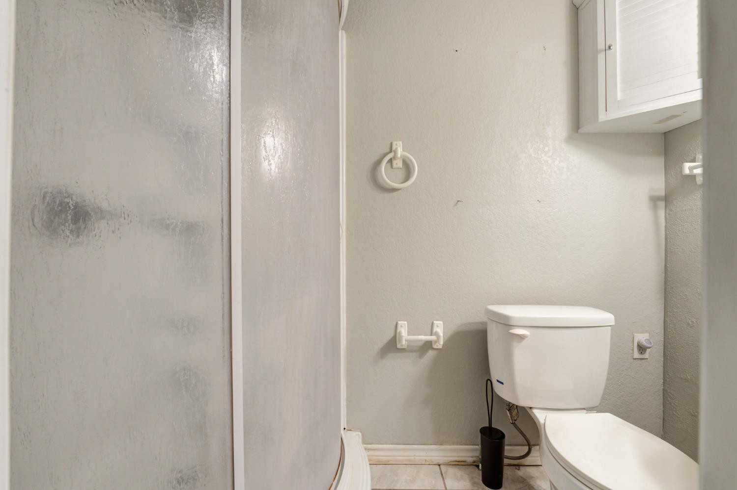 4409 49th Street Lubbock, TX 79414 - Photo 48 of 49 a white toilet sitting next to a bathroom sink