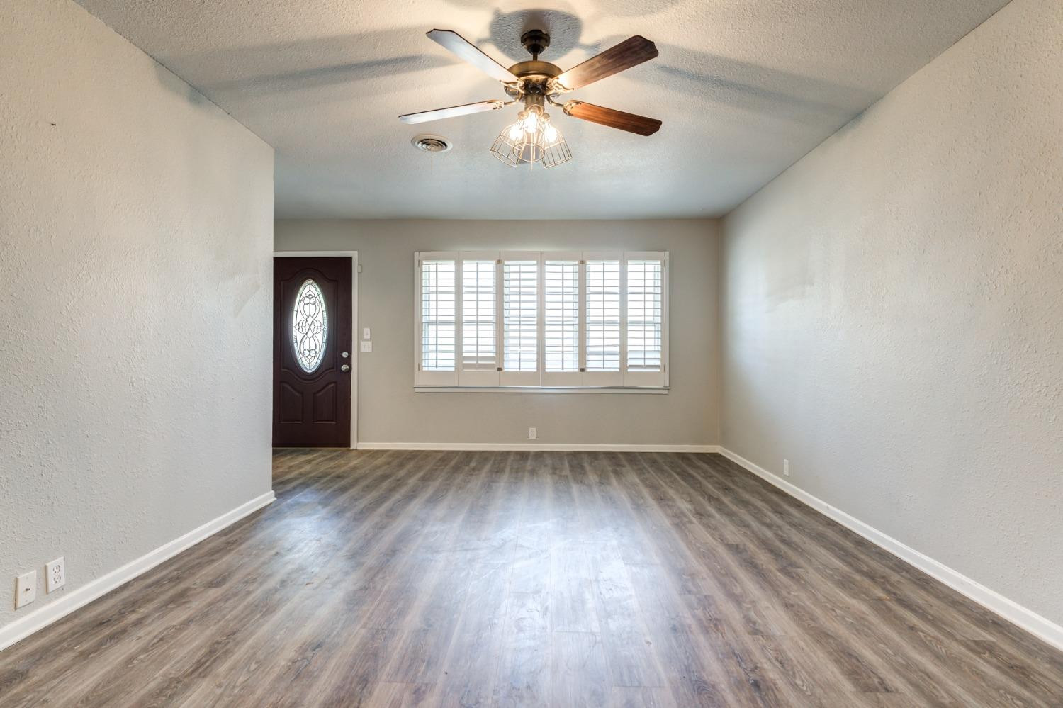 4409 49th Street Lubbock, TX 79414 - Photo 8 of 49 wooden floor in an empty room with a window
