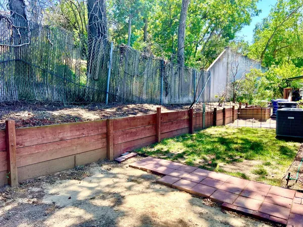 a view of a backyard with sitting area