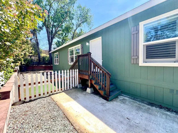 a view of a small yard with wooden fence