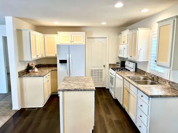 a kitchen with a stove a sink and a refrigerator