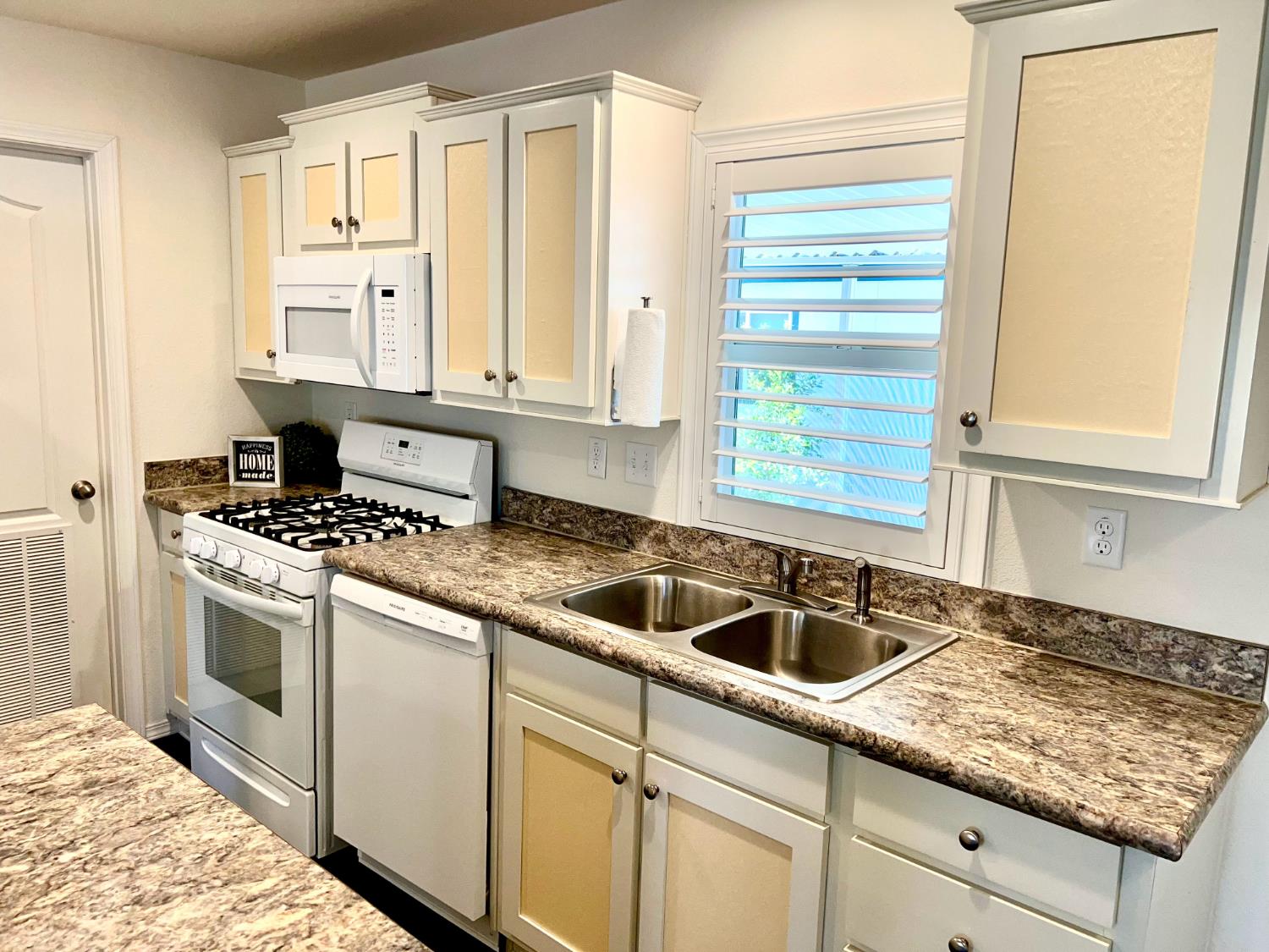 53 Saxton Circle, Unit 53 Citrus Heights, CA 95621 - Photo 7 of 19 a kitchen with granite countertop a sink stainless steel appliances white cabinets and a window