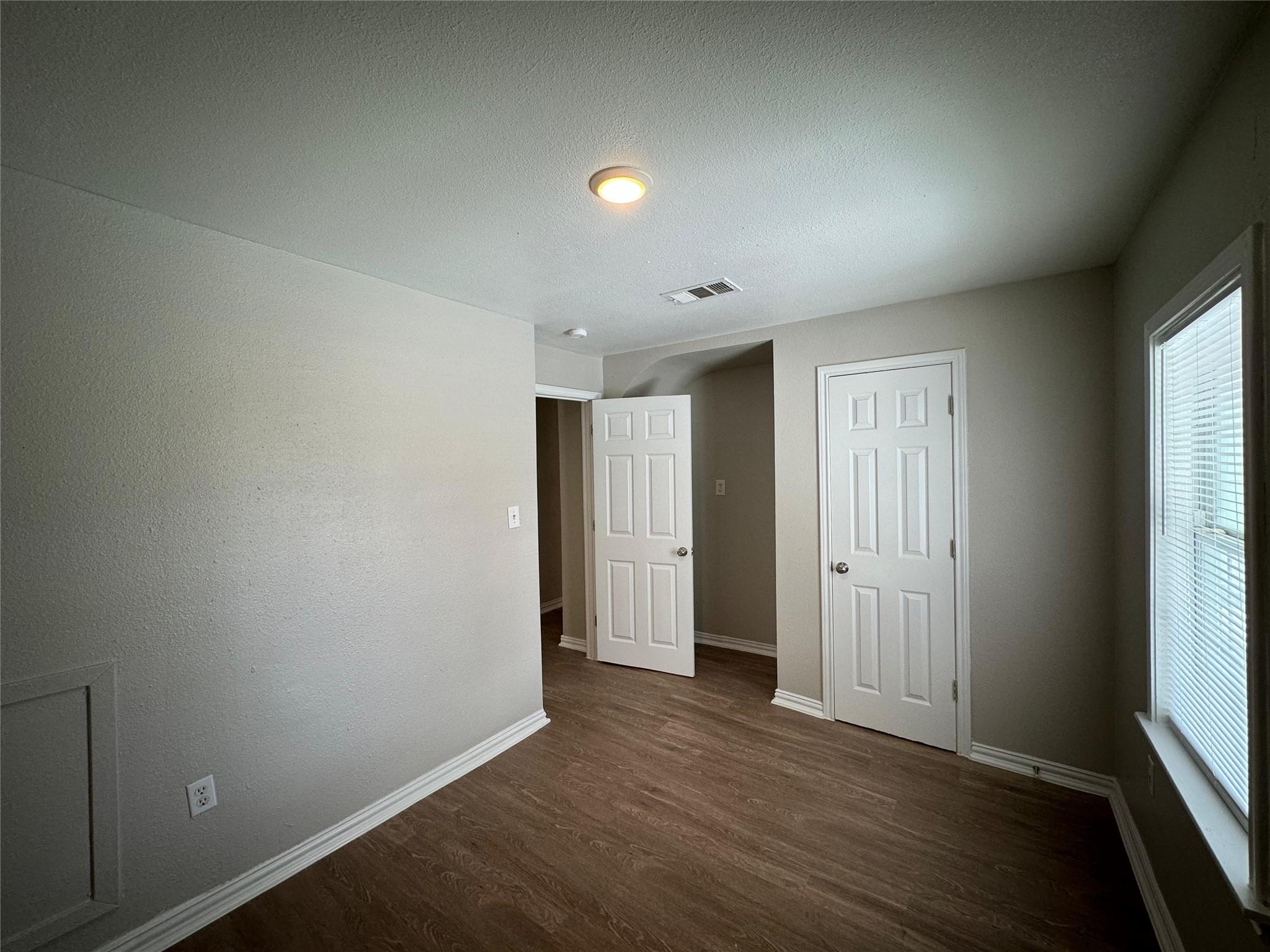 101 South Lockhart Street, Unit A Manor, TX 78653 - Photo 14 of 21 an empty room with wooden floor and windows