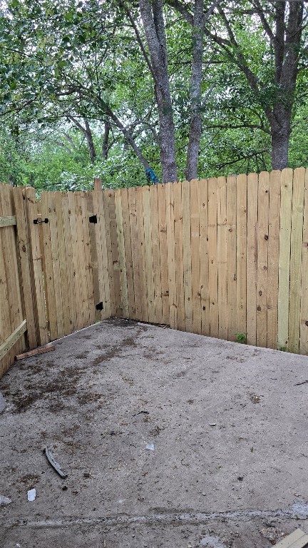 101 South Lockhart Street, Unit A Manor, TX 78653 - Photo 16 of 21 a view of backyard with large trees and wooden fence