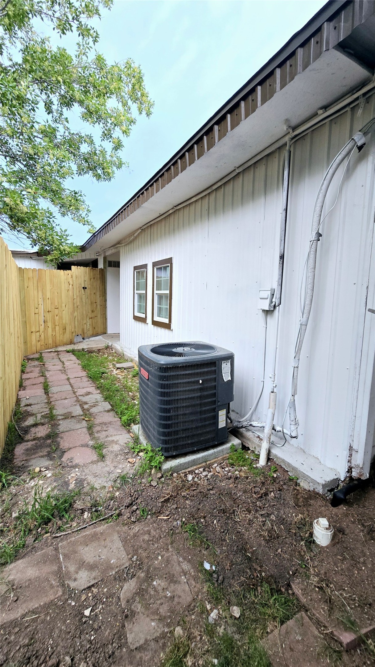 101 South Lockhart Street, Unit A Manor, TX 78653 - Photo 17 of 21 a backyard of a house with a yard and garage