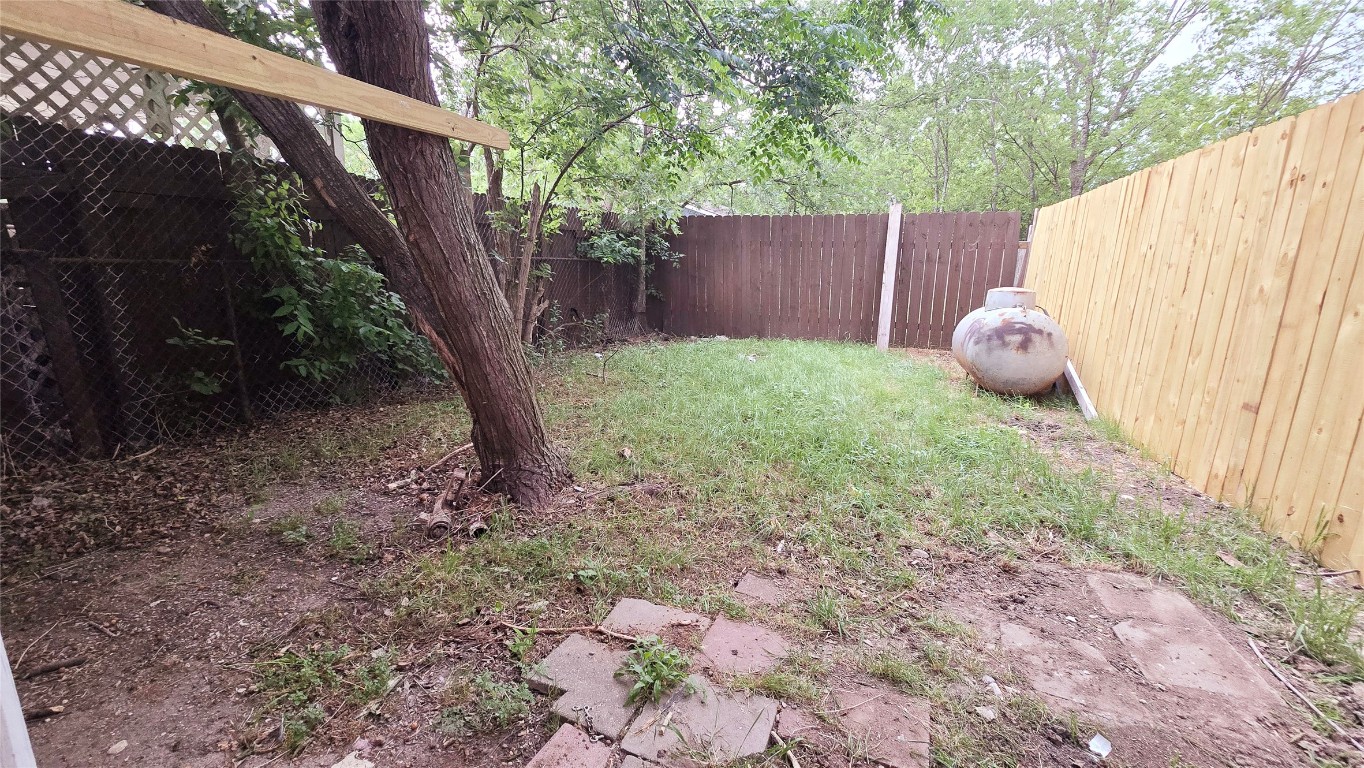 101 South Lockhart Street, Unit A Manor, TX 78653 - Photo 20 of 21 a backyard of a house with lots of green space