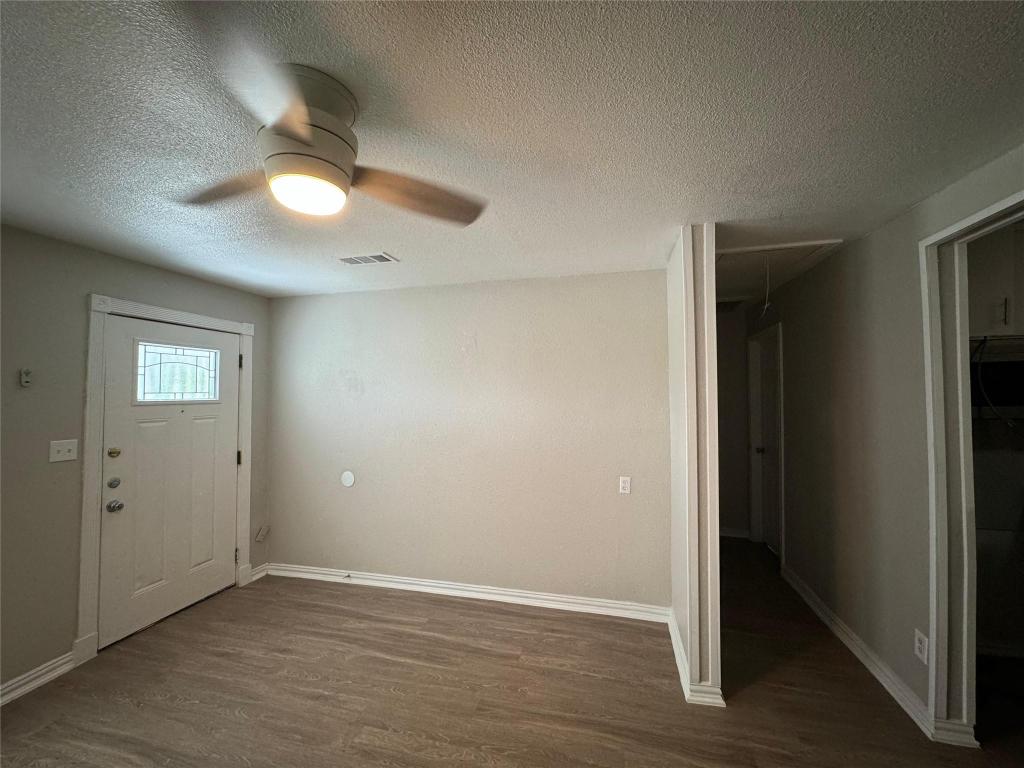 101 South Lockhart Street, Unit A Manor, TX 78653 - Photo 5 of 21 an empty room with wooden floor and windows