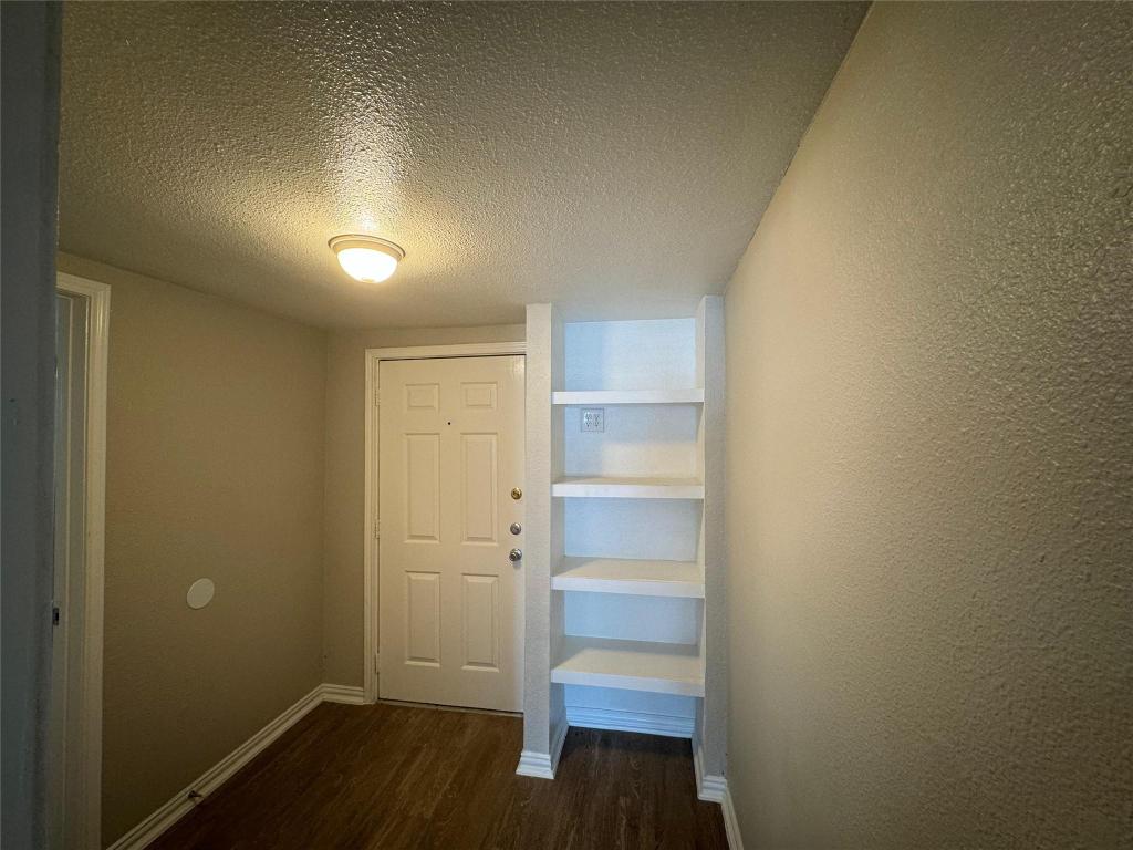 101 South Lockhart Street, Unit A Manor, TX 78653 - Photo 8 of 21 a view of walk in closet with empty racks
