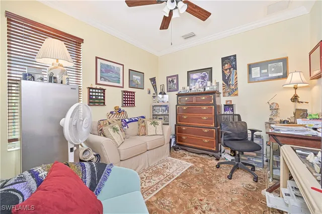 a living room with furniture and a dresser