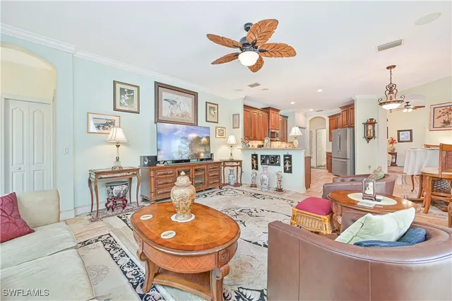 a living room with fireplace furniture and a chandelier