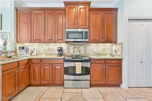 a kitchen with stainless steel appliances granite countertop a stove top oven a sink and dishwasher