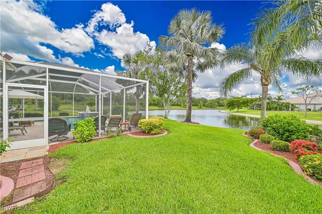a view of a house with backyard and sitting area