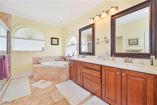 a bathroom with a granite countertop sink mirror vanity and toilet