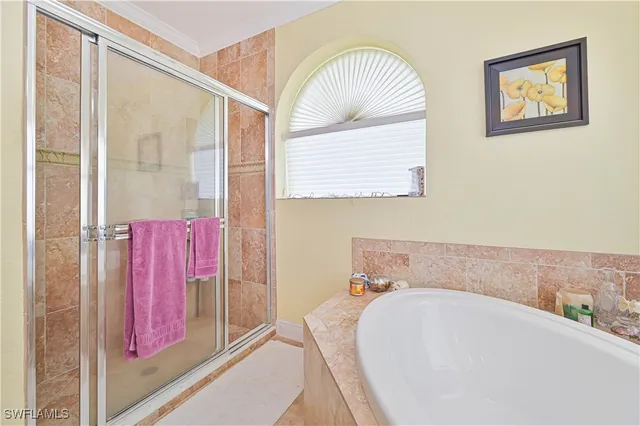 a bathroom with a tub and a large window