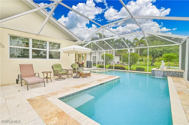 a view of a swimming pool with outdoor seating