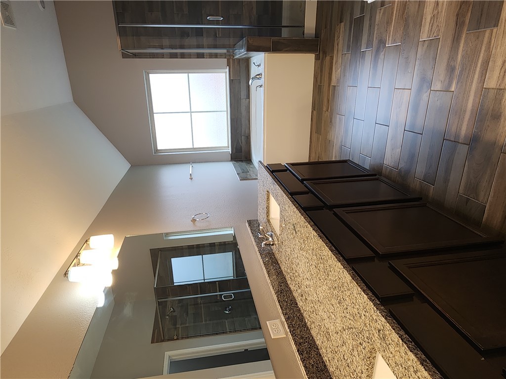 4015 Dunlap Loop College Station, TX 77845 - Photo 17 of 40 a bathroom with a sink a vanity and a large mirror