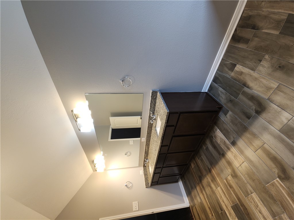 4015 Dunlap Loop College Station, TX 77845 - Photo 19 of 40 a spacious bathroom with a granite countertop sink and a mirror
