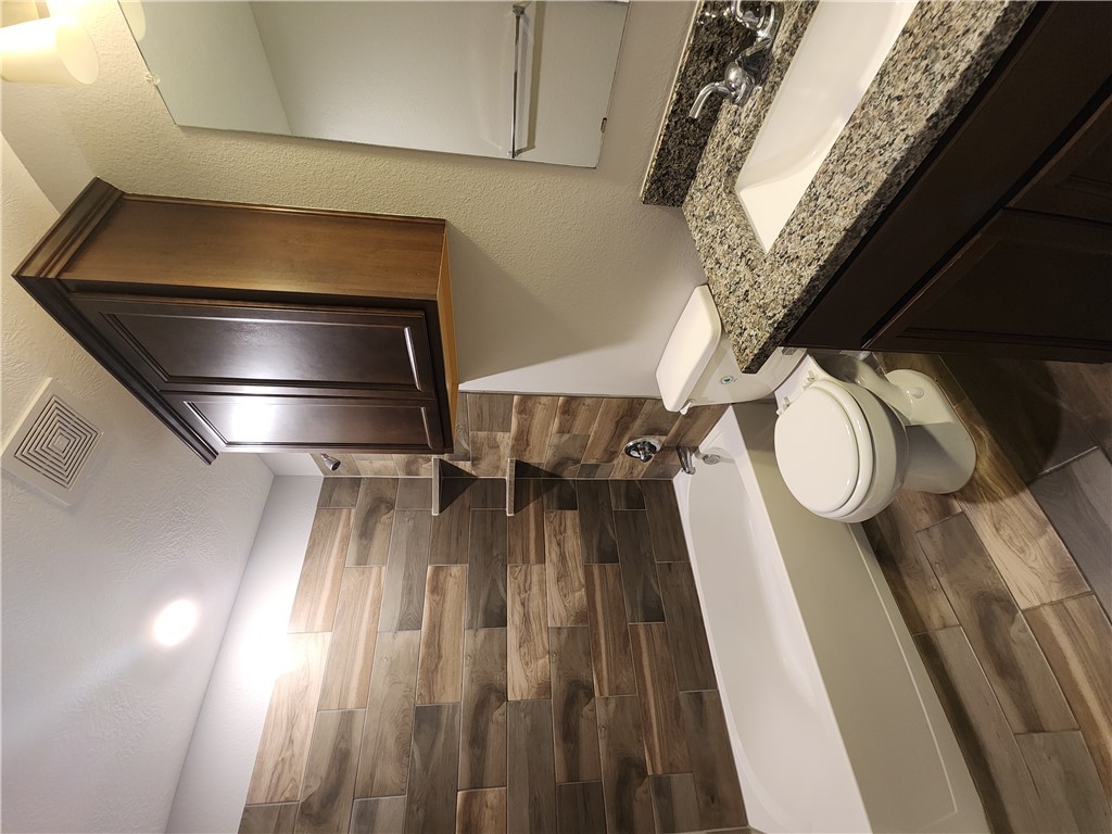 4015 Dunlap Loop College Station, TX 77845 - Photo 25 of 40 a bathroom with a granite countertop toilet sink and mirror