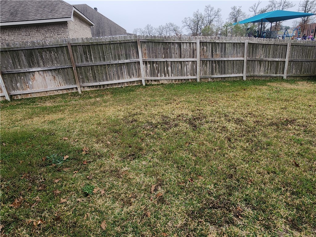 4015 Dunlap Loop College Station, TX 77845 - Photo 35 of 40 a view of a backyard with a large window and wooden fence