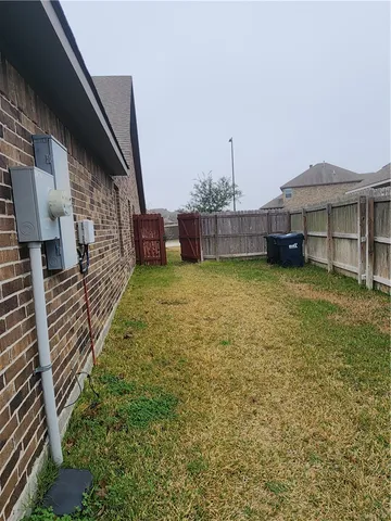 a view of a house with a yard and sitting area