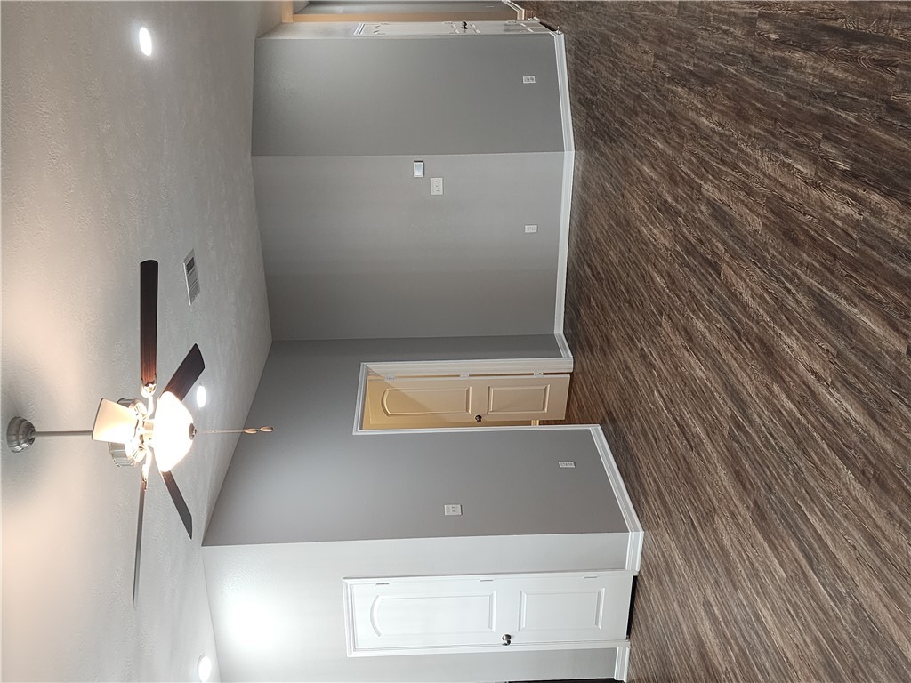 4015 Dunlap Loop College Station, TX 77845 - Photo 5 of 40 a view of an empty room with wooden floor and a ceiling fan