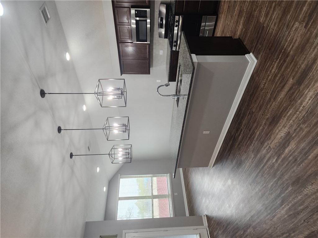 4015 Dunlap Loop College Station, TX 77845 - Photo 6 of 40 a kitchen with stainless steel appliances granite countertop a sink a stove a microwave and wooden floor