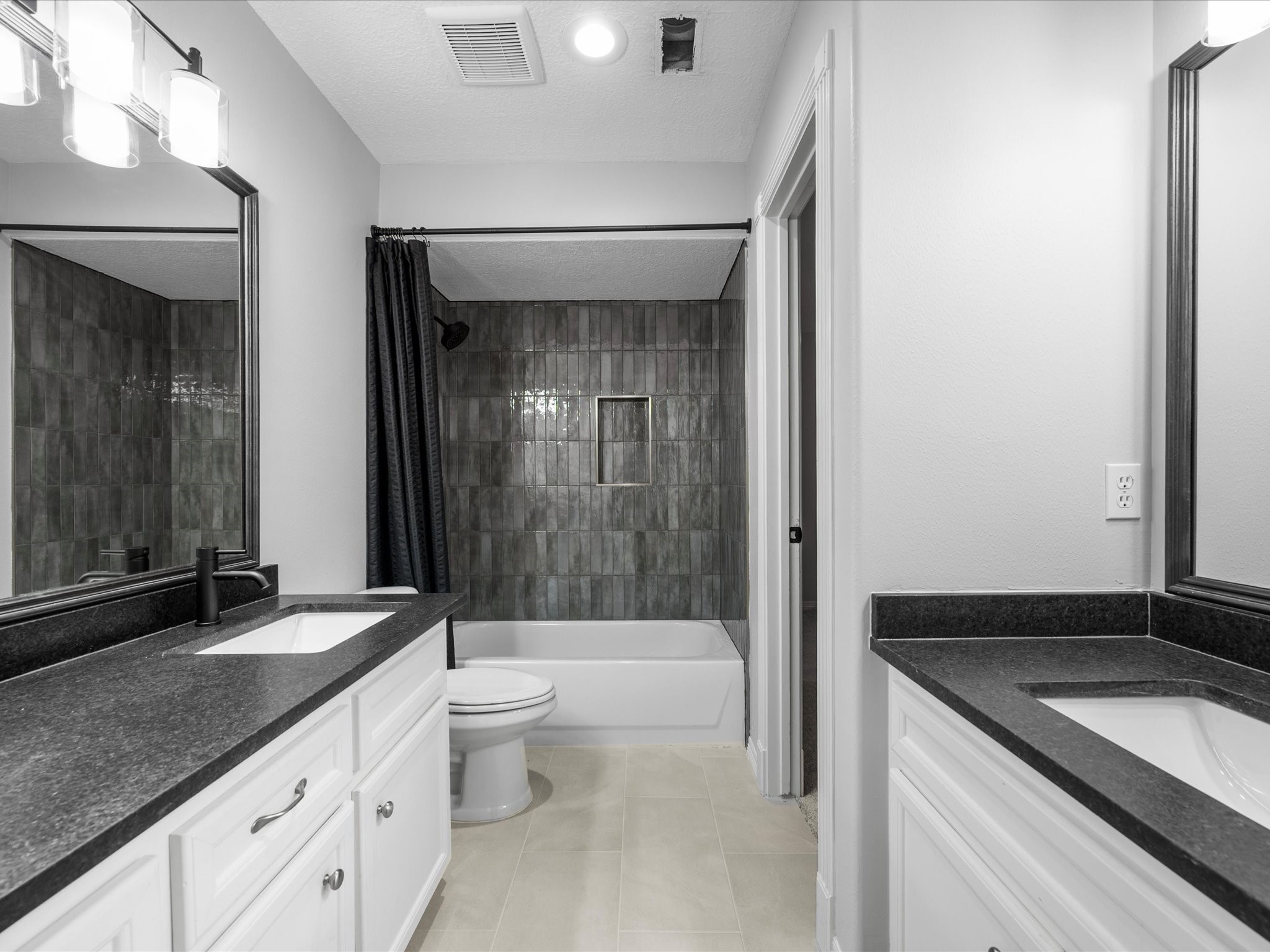 5910 Center Ct Drive Spring, TX 77379 - Photo 30 of 50 A fully updated shared en-suite bathroom features dual sinks, modern finishes, and a tub/shower combination designed with both style and functionality in mind.