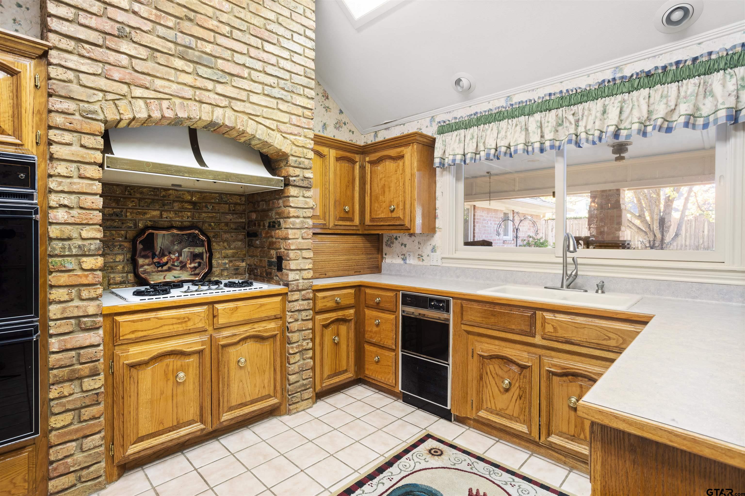 1701 Tall Timber Drive Flint, TX 75762 - Photo 12 of 40 a kitchen with stainless steel appliances granite countertop a sink and cabinets