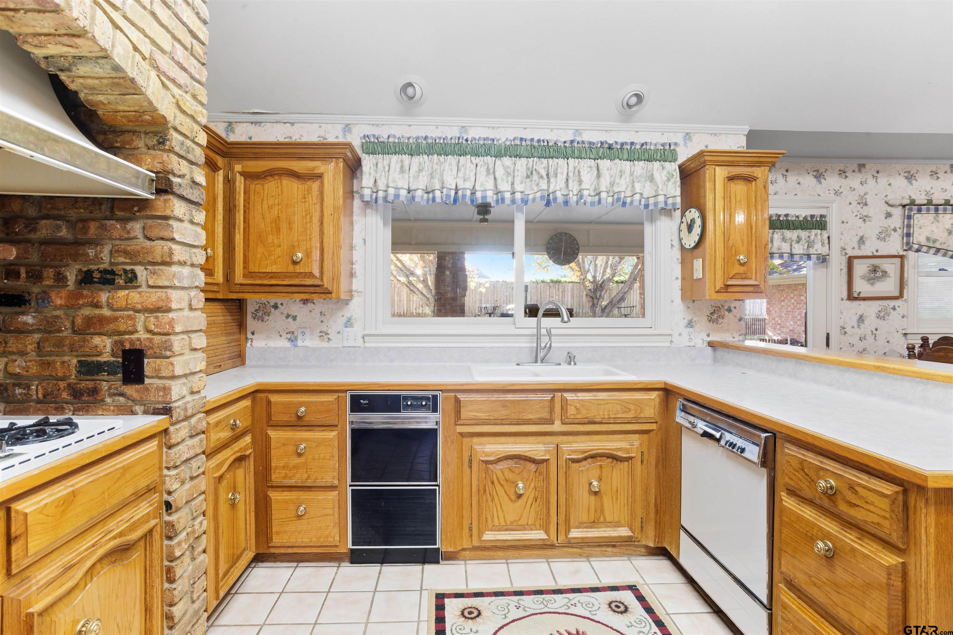 1701 Tall Timber Drive Flint, TX 75762 - Photo 13 of 40 a kitchen with stainless steel appliances granite countertop a sink and cabinets