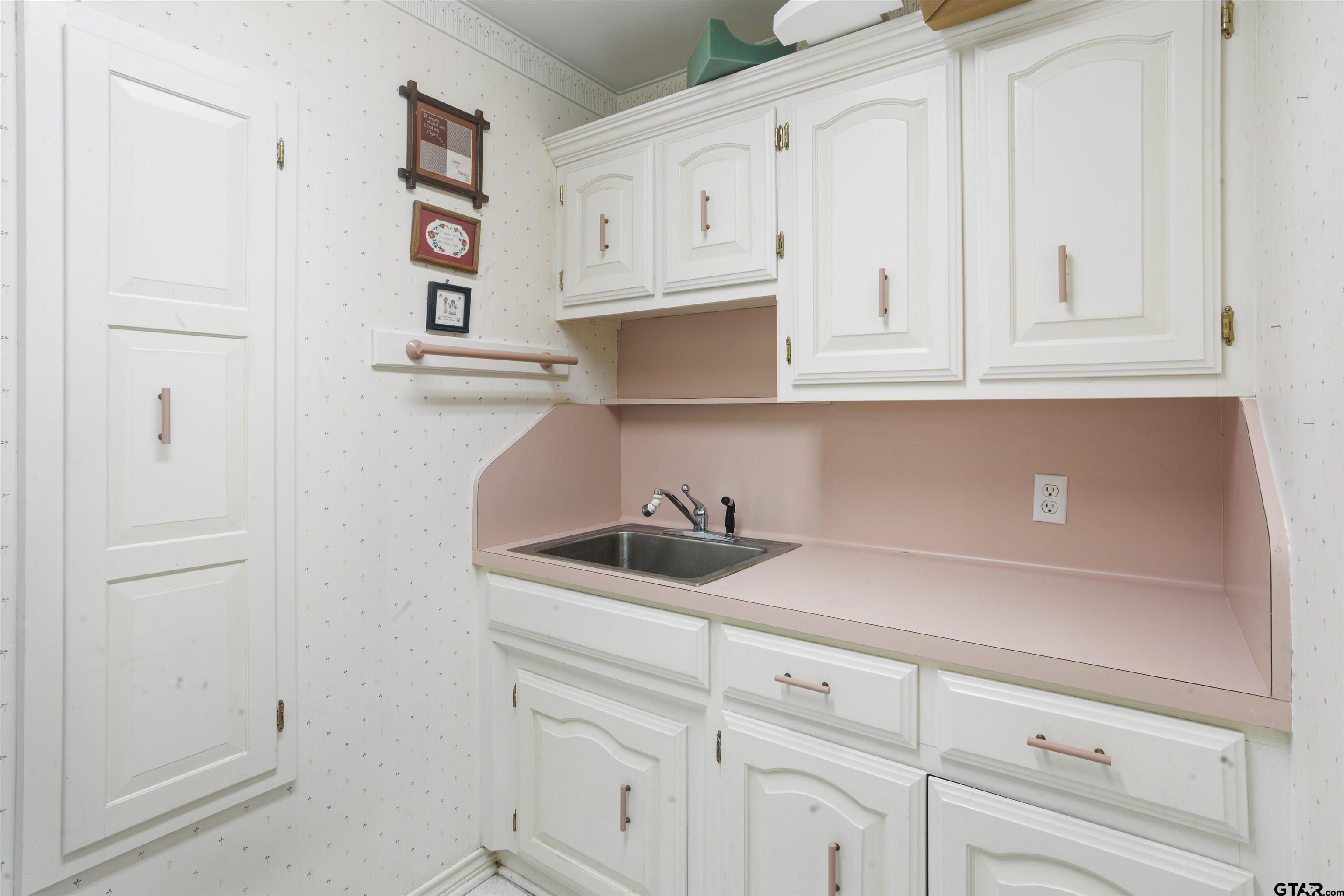 1701 Tall Timber Drive Flint, TX 75762 - Photo 25 of 40 a kitchen with white cabinets and white appliances